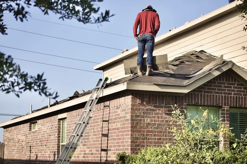 Professional roofer working on a residential roof in Marshall Ford